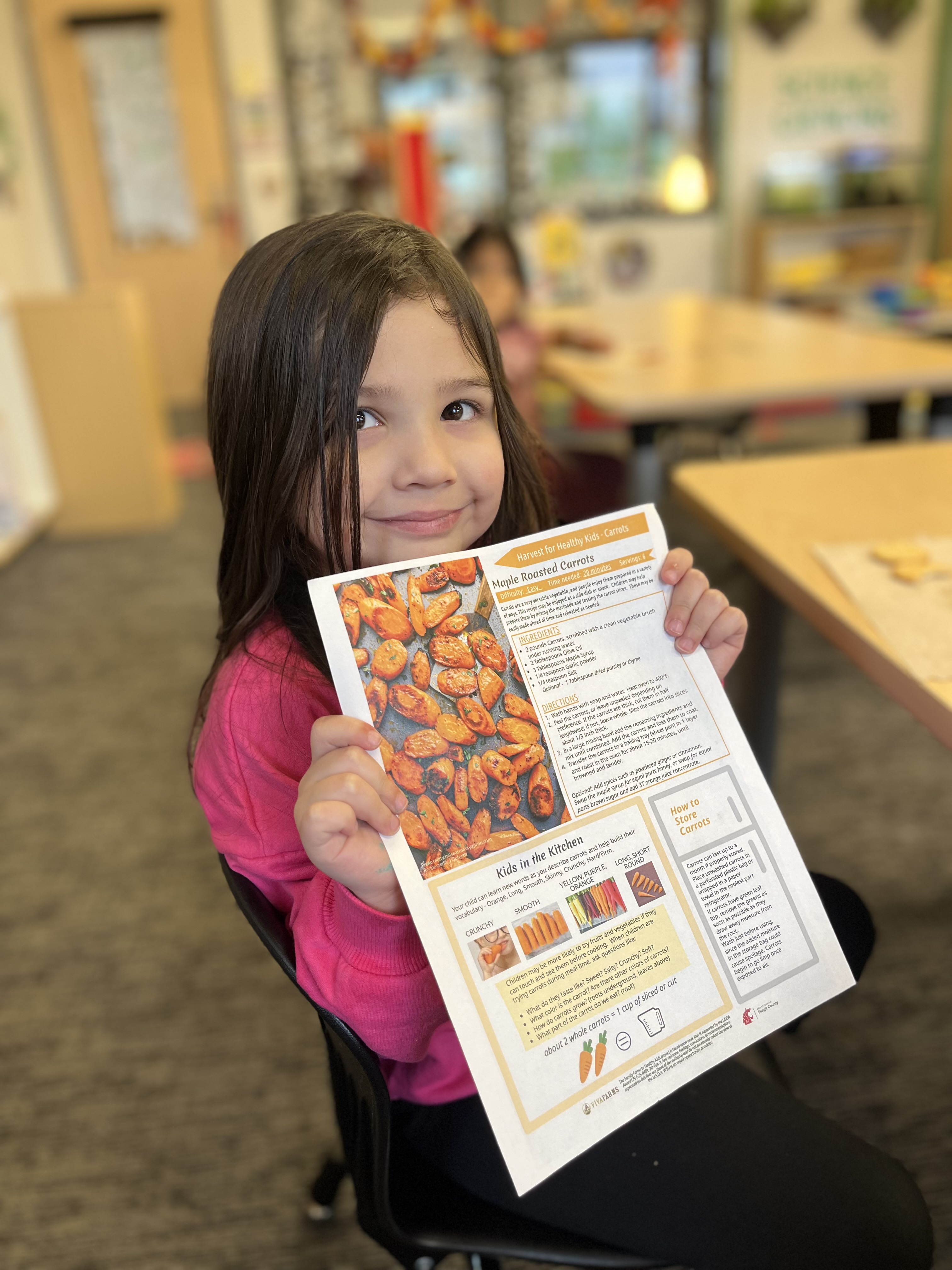 student holding up a recipie